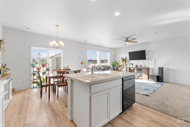 2318 Oxon St, Caldwell, ID 83605 - kitchen featuring a sink, black dishwasher, open floor plan, a chandelier, and an island with sink