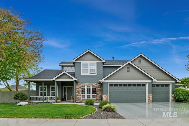 10450 W Antietam St, Boise, ID 83709 - craftsman inspired home featuring a garage, fence, a front yard, and stone siding