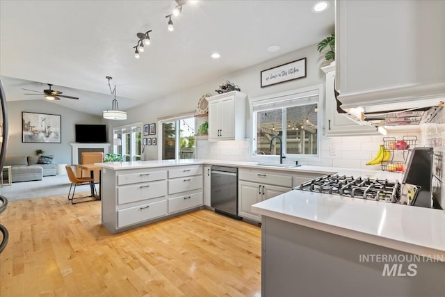 10450 W Antietam St, Boise, ID 83709 - kitchen with a sink, a peninsula, dishwashing machine, light countertops, and a ceiling fan