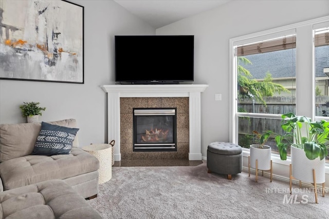10450 W Antietam St, Boise, ID 83709 - carpeted living room with vaulted ceiling and a tile fireplace