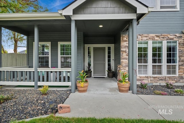 10450 W Antietam St, Boise, ID 83709 - view of exterior entry with fence, covered porch, and stone siding