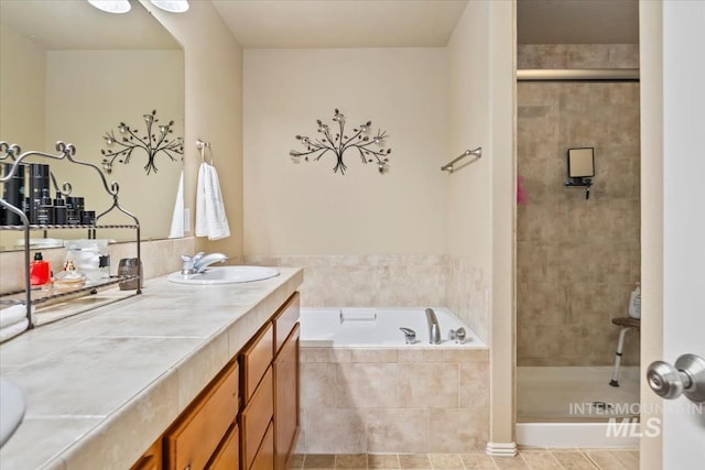 10450 W Antietam St, Boise, ID 83709 - full bathroom with vanity, a shower stall, tile patterned floors, and a garden tub
