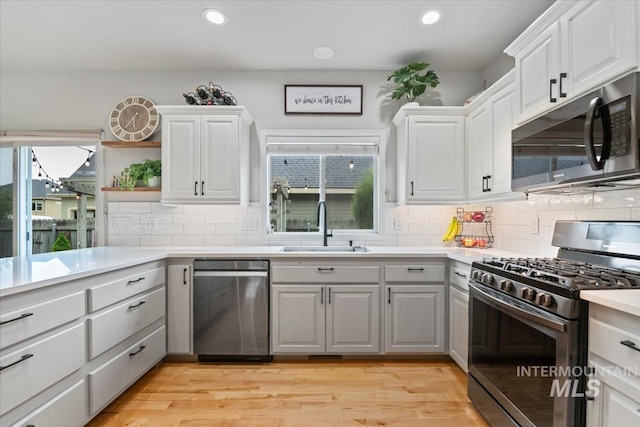 10450 W Antietam St, Boise, ID 83709 - kitchen with appliances with stainless steel finishes, a sink, light countertops, gray cabinets, and decorative backsplash