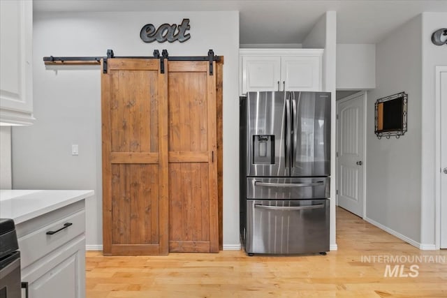 10450 W Antietam St, Boise, ID 83709 - kitchen featuring white cabinets, stainless steel refrigerator with ice dispenser, light wood finished floors, and light countertops