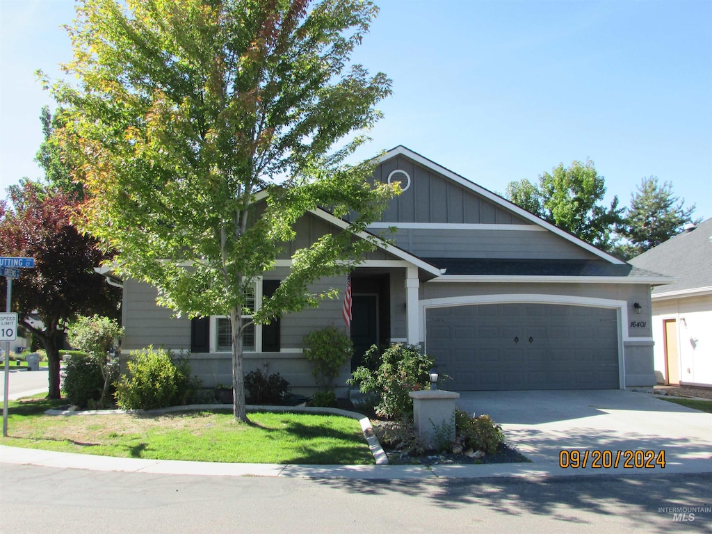 view of front of property with a front lawn and a garage