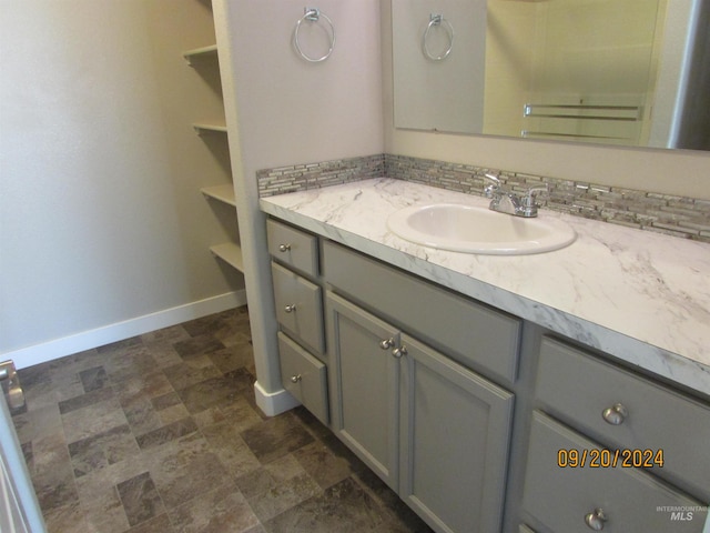 bathroom featuring vanity and decorative backsplash