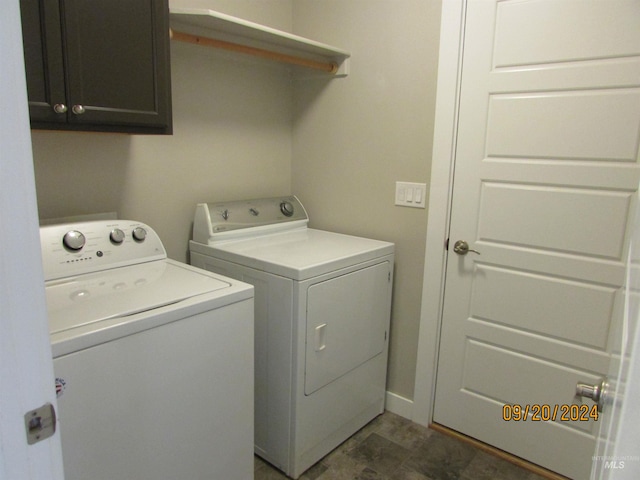 clothes washing area featuring washing machine and dryer and cabinets