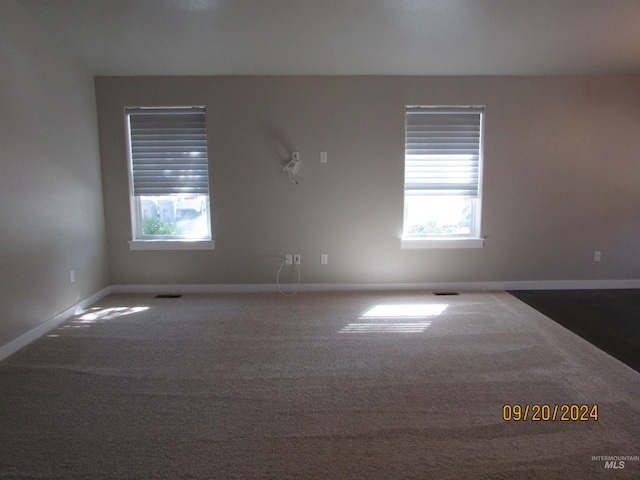 empty room featuring dark colored carpet