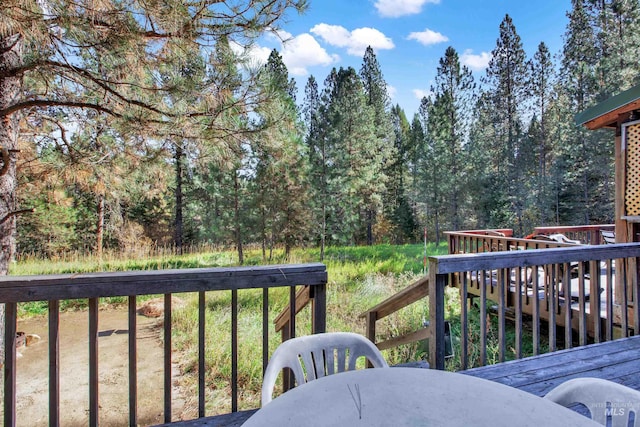 wooden terrace with a wooded view