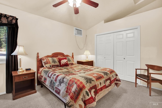 bedroom featuring a closet, carpet, vaulted ceiling, and a wall unit AC