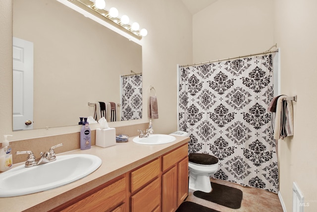 full bath with tile patterned floors, toilet, double vanity, and a sink