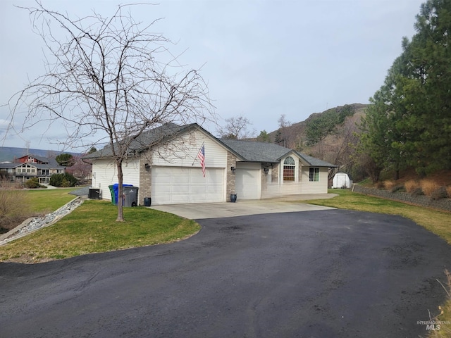 ranch-style house with a front lawn, cooling unit, a garage, and driveway