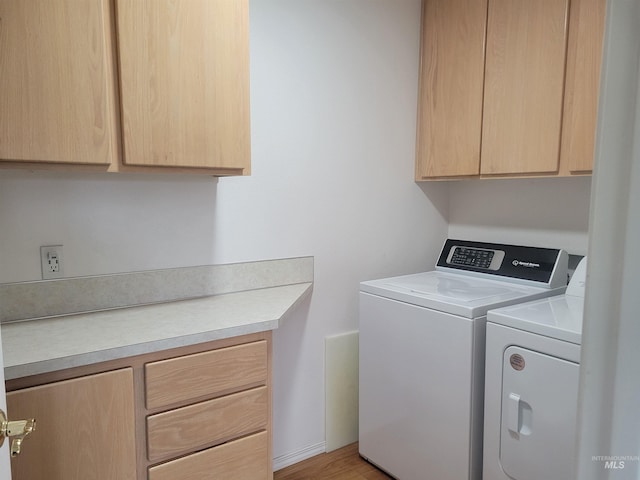 washroom with cabinet space and washing machine and clothes dryer