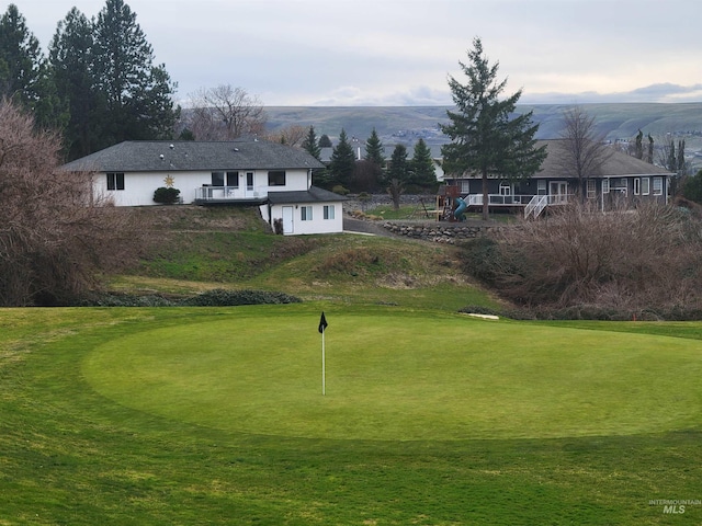 view of home's community with a mountain view and a yard