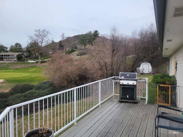 wooden terrace with a grill