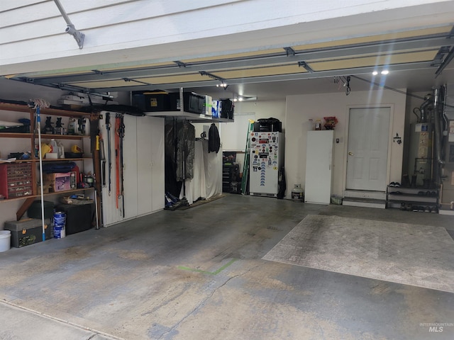 garage with water heater and refrigerator