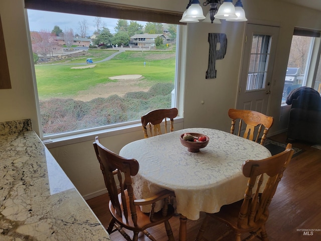 dining area featuring baseboards, an inviting chandelier, and dark wood-style flooring