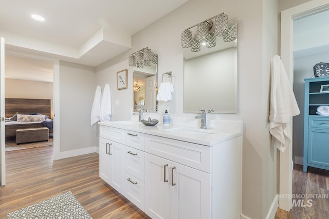 5696 N Kriscliffe, Boise, ID 83704 - ensuite bathroom with double vanity, wood finished floors, baseboards, and recessed lighting