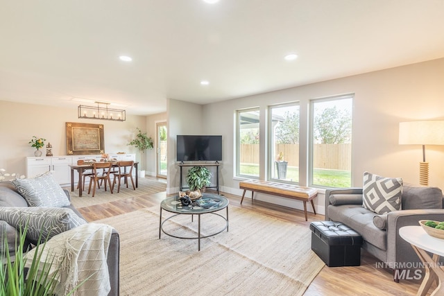 5696 N Kriscliffe, Boise, ID 83704 - living area featuring light wood-style floors, a chandelier, recessed lighting, and baseboards