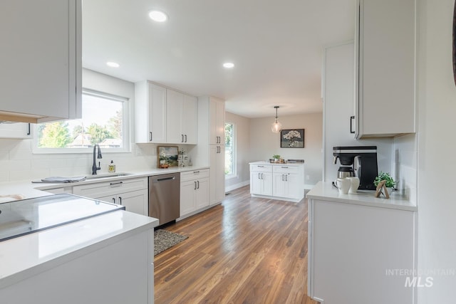 5696 N Kriscliffe, Boise, ID 83704 - kitchen featuring stainless steel dishwasher, decorative backsplash, white cabinetry, light wood-style floors, and light countertops
