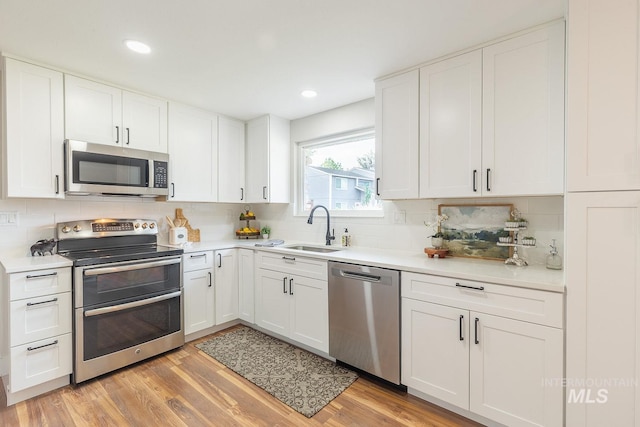 5696 N Kriscliffe, Boise, ID 83704 - kitchen with appliances with stainless steel finishes, a sink, backsplash, light countertops, and recessed lighting