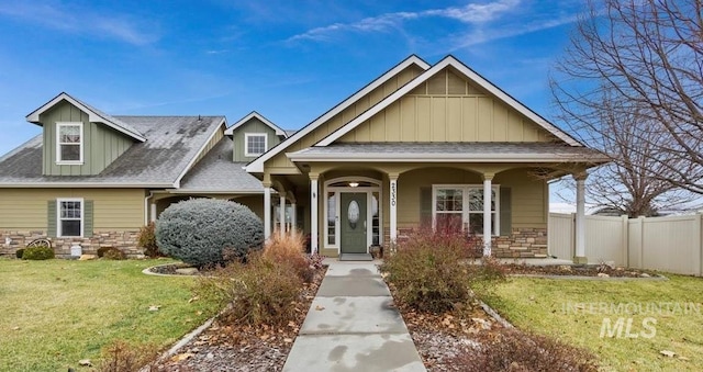 craftsman-style house with a front yard and covered porch