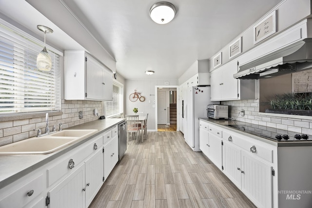 827 Alturas Dr N, Twin Falls, ID 83301 - kitchen with black electric cooktop, stainless steel dishwasher, a sink, decorative backsplash, and white cabinetry