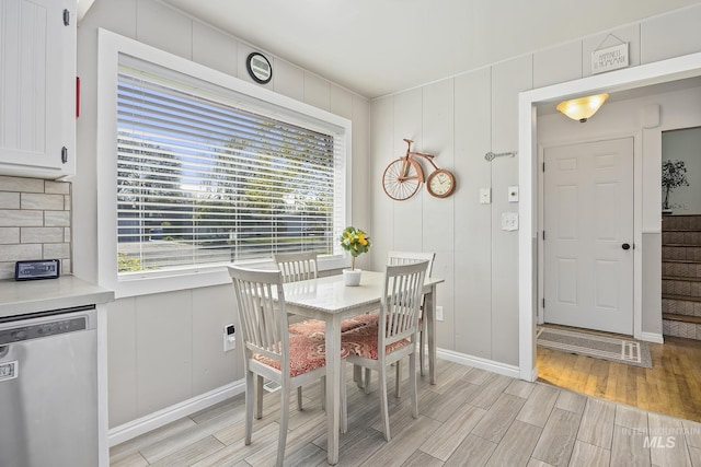 827 Alturas Dr N, Twin Falls, ID 83301 - dining space with wood finish floors, a decorative wall, and baseboards