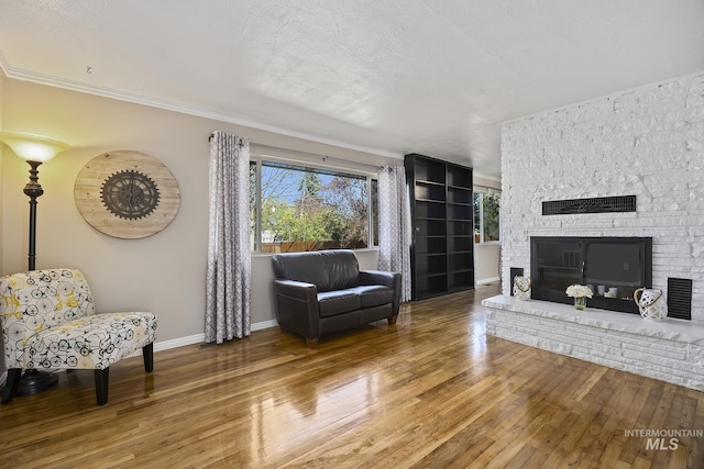 827 Alturas Dr N, Twin Falls, ID 83301 - living room featuring hardwood / wood-style floors, a brick fireplace, baseboards, and ornamental molding