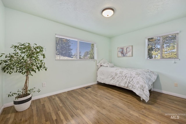 827 Alturas Dr N, Twin Falls, ID 83301 - bedroom with baseboards and wood finished floors