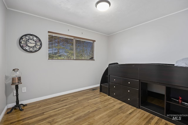 827 Alturas Dr N, Twin Falls, ID 83301 - bedroom with baseboards, wood finished floors, and crown molding