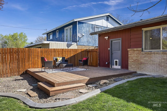 827 Alturas Dr N, Twin Falls, ID 83301 - rear view of house with brick siding, a wooden deck, and fence