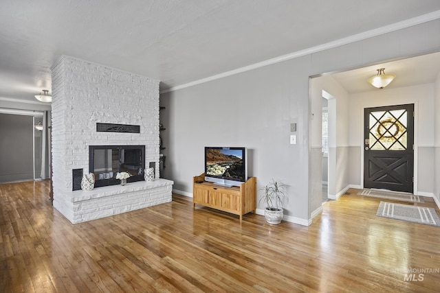 827 Alturas Dr N, Twin Falls, ID 83301 - unfurnished living room with hardwood / wood-style flooring, baseboards, a fireplace, and ornamental molding