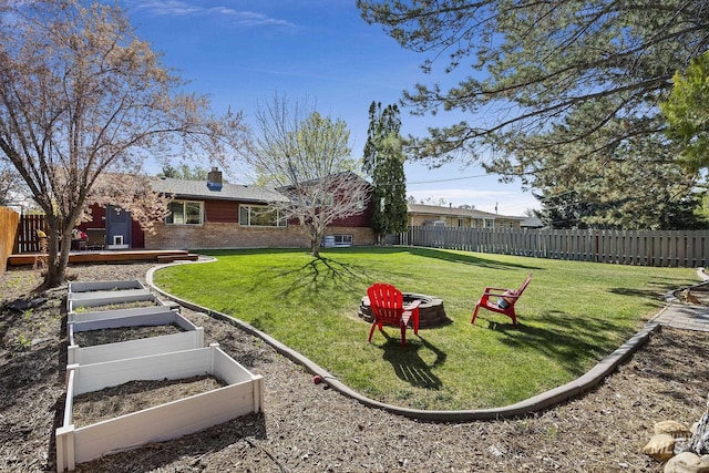 827 Alturas Dr N, Twin Falls, ID 83301 - view of yard with a fenced backyard, a fire pit, a deck, and a vegetable garden