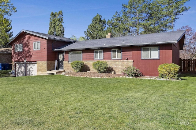 827 Alturas Dr N, Twin Falls, ID 83301 - split level home featuring a garage, brick siding, a front yard, and fence