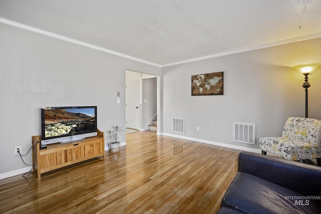 827 Alturas Dr N, Twin Falls, ID 83301 - living area with wood finished floors, visible vents, and ornamental molding