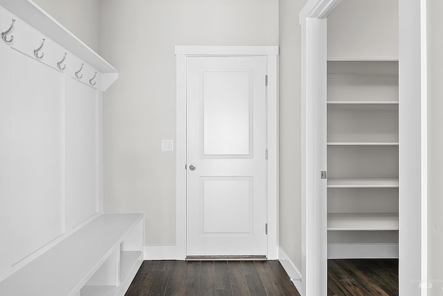 mudroom with dark wood-style flooring and baseboards