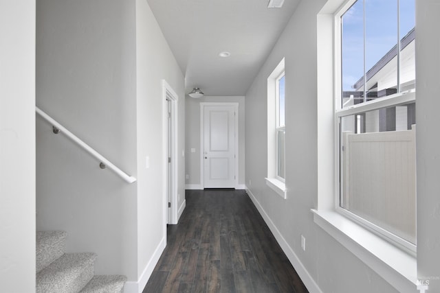 hall featuring stairway, dark wood finished floors, and baseboards