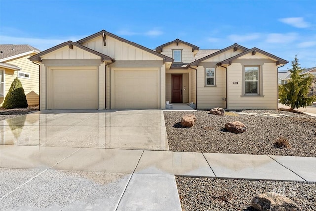 view of front facade featuring an attached garage, board and batten siding, and driveway