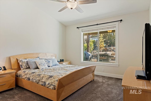 bedroom featuring a ceiling fan, lofted ceiling, baseboards, and dark colored carpet