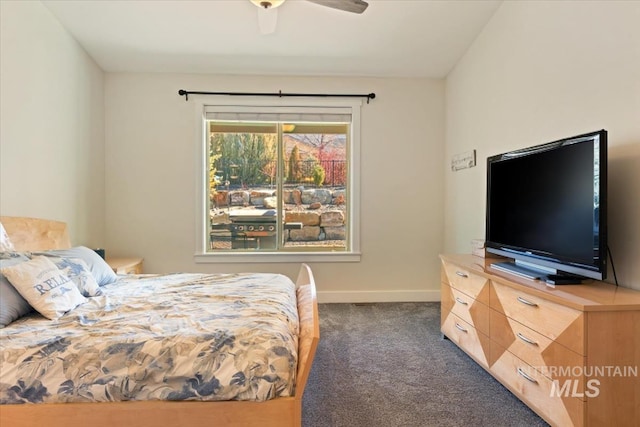 bedroom with a ceiling fan, baseboards, and dark colored carpet