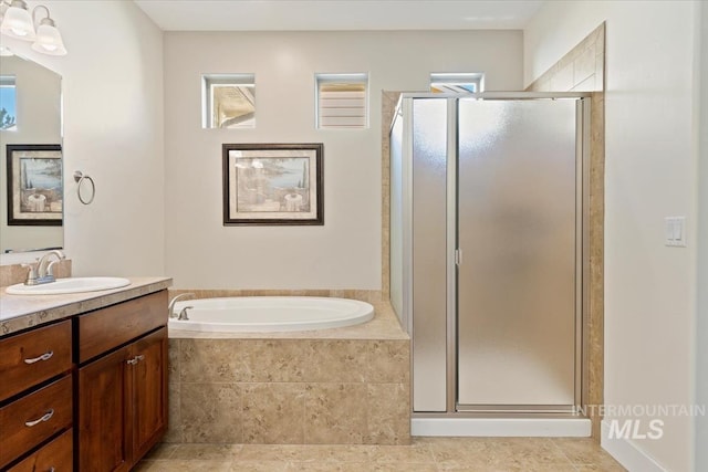 bathroom featuring vanity, a garden tub, and a stall shower