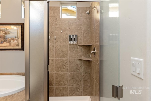 bathroom with a garden tub and a stall shower