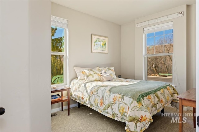 bedroom with baseboards and carpet flooring