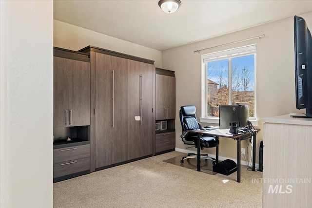 office space with light carpet and baseboards