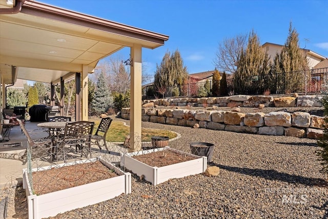 view of yard with a garden, a patio area, and fence