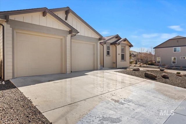 view of front of home featuring board and batten siding, concrete driveway, and an attached garage