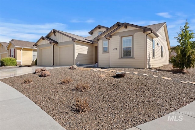 single story home with board and batten siding, concrete driveway, and an attached garage