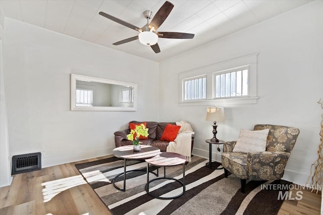 living room with ceiling fan and light wood-type flooring