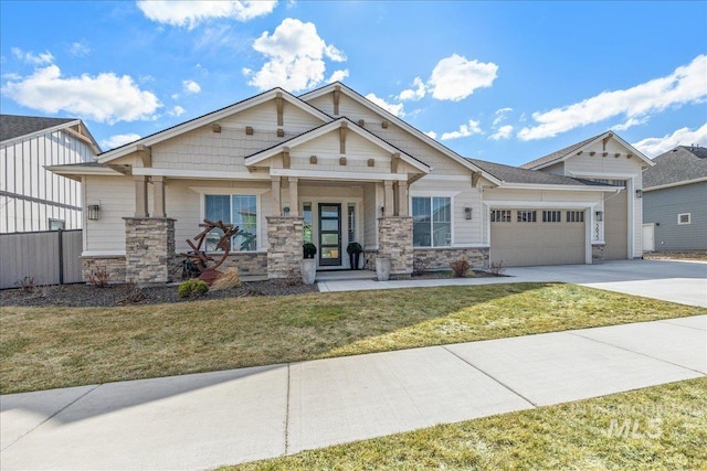 craftsman-style house featuring driveway, stone siding, an attached garage, and a front yard